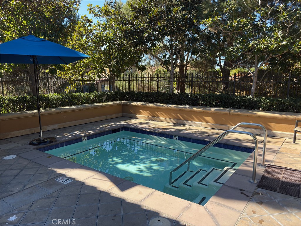 102 Roadrunner Irvine, CA 92603 - Photo 19 of 20 a view of a backyard with lawn chairs under an umbrella