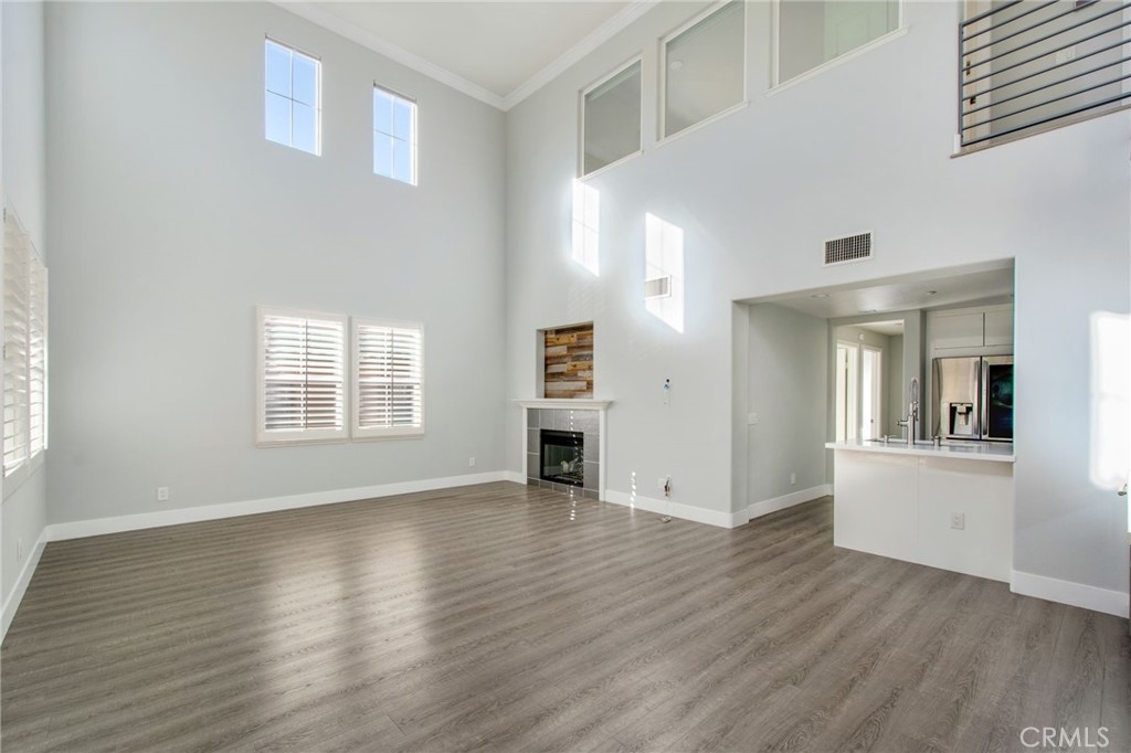 102 Roadrunner Irvine, CA 92603 - Photo 2 of 20 an empty room with wooden floor and windows