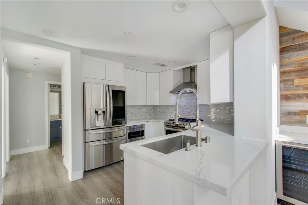 102 Roadrunner Irvine, CA 92603 - Photo 3 of 20 a kitchen with stainless steel appliances a sink a stove and a refrigerator