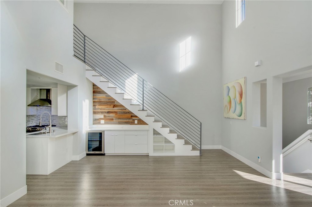 102 Roadrunner Irvine, CA 92603 - Photo 5 of 20 a view of a hallway with wooden floor and staircase