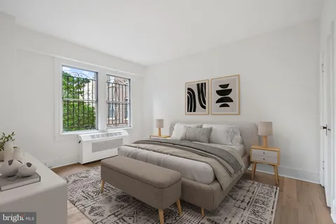 a bedroom with a bed and a couch