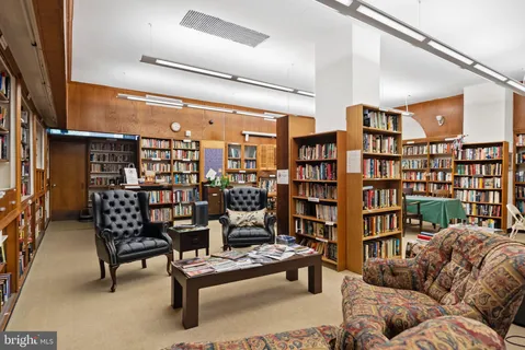 a reading room with furniture and book shelf
