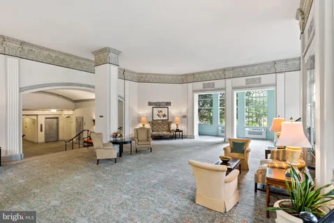 a living room with furniture and large windows