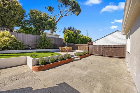 a view of backyard with swimming pool and outdoor seating