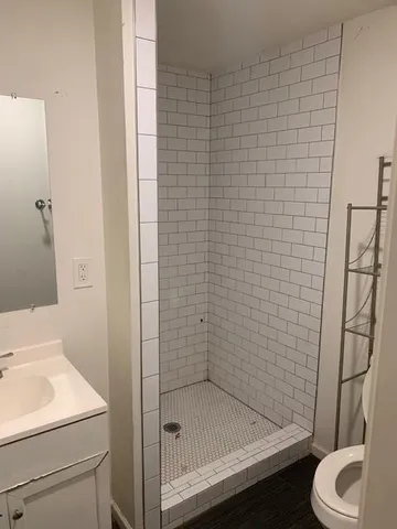 a bathroom with a sink toilet and shower