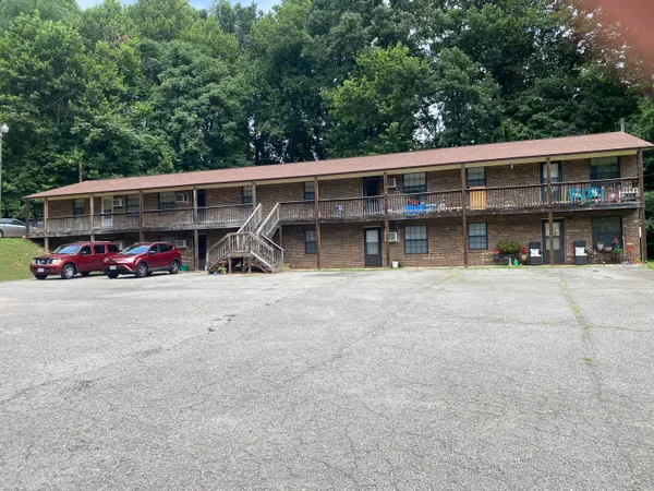 a view of house with outdoor space and parking