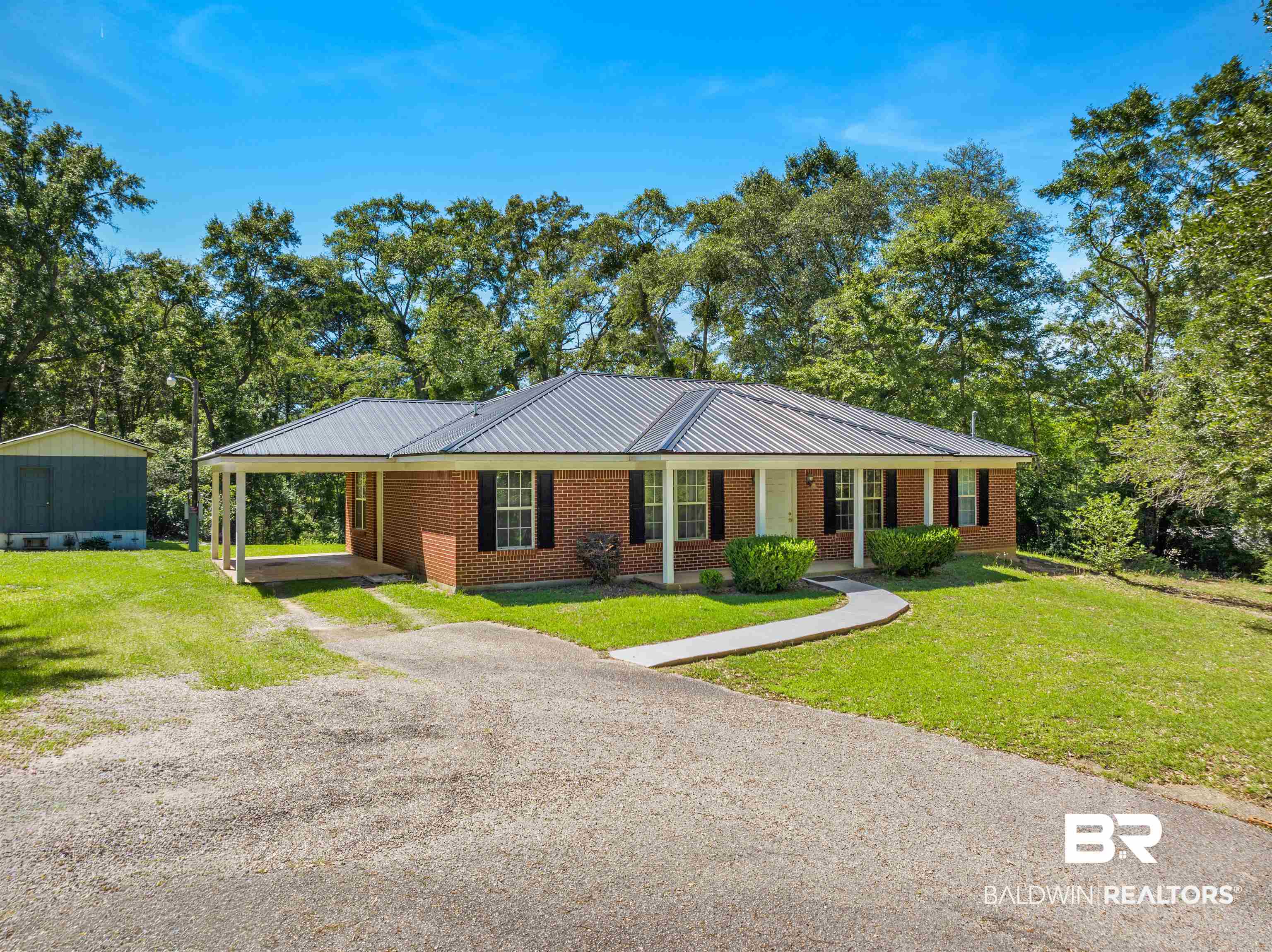 35893 Pine Road South Stapleton, AL 36578 - Photo 1 of 31 Brick ranch-style home featuring a metal roof and a covered carport