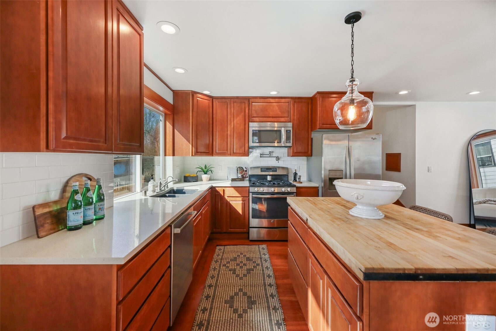 2418 Callow Road Lake Stevens, WA 98258 - Photo 7 of 40 a kitchen with stainless steel appliances granite countertop a sink a stove and a wooden floors