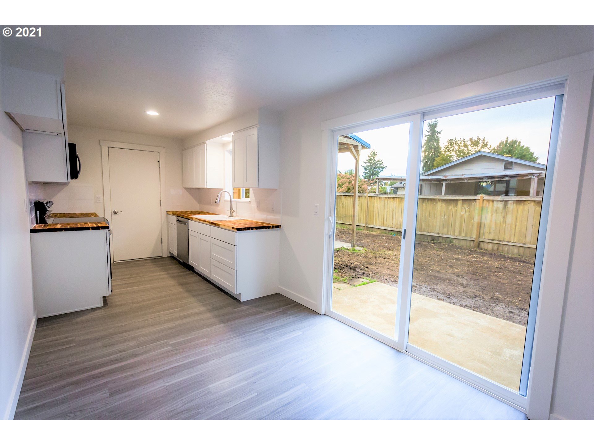 2302 Grovedale Drive Springfield, OR 97477 - Photo 15 of 29 a kitchen with stainless steel appliances wooden floor and a large window