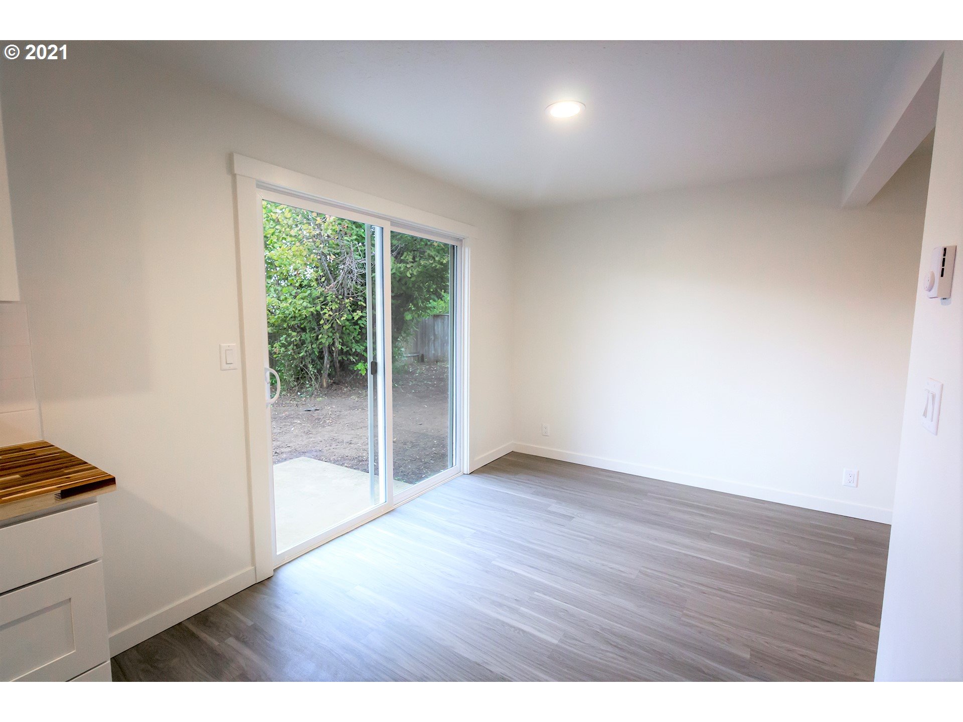 2302 Grovedale Drive Springfield, OR 97477 - Photo 19 of 29 a view of an empty room with wooden floor and a window