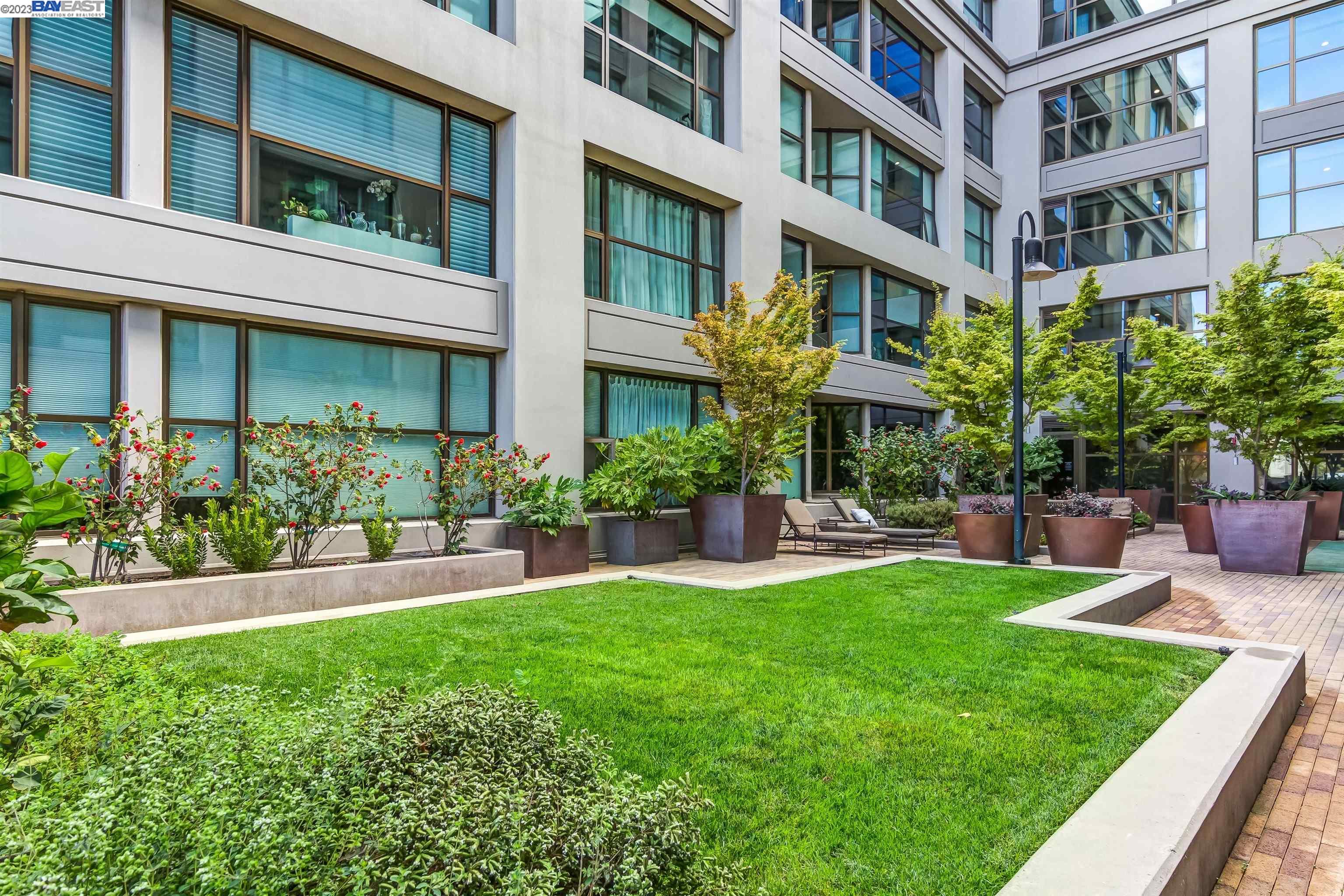 311 2nd Street, Unit 804 Oakland, CA 94607 - Photo 14 of 17 a front view of a building with a garden and plants