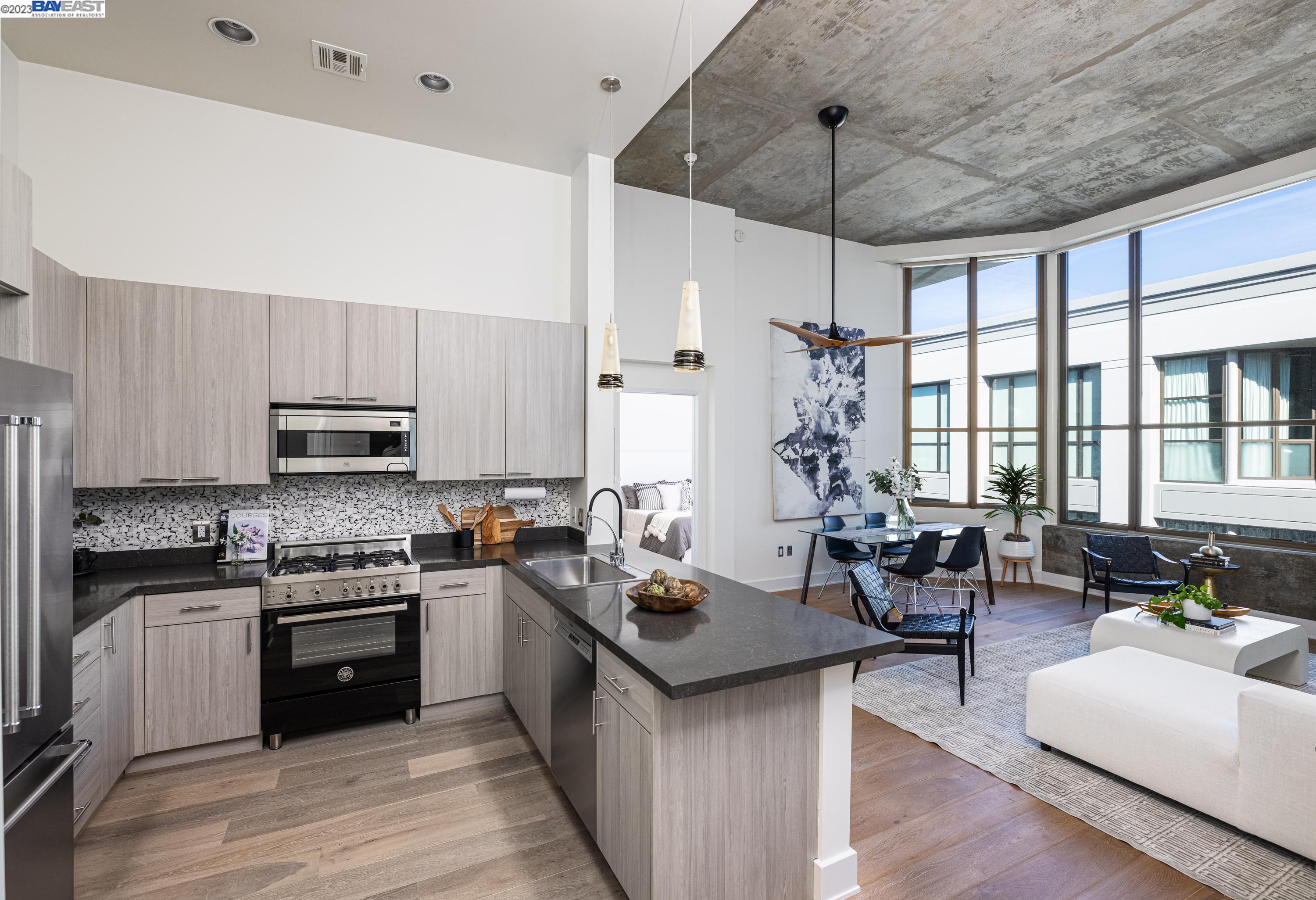 311 2nd Street, Unit 804 Oakland, CA 94607 - Photo 2 of 17 a kitchen with granite countertop a stove and cabinets