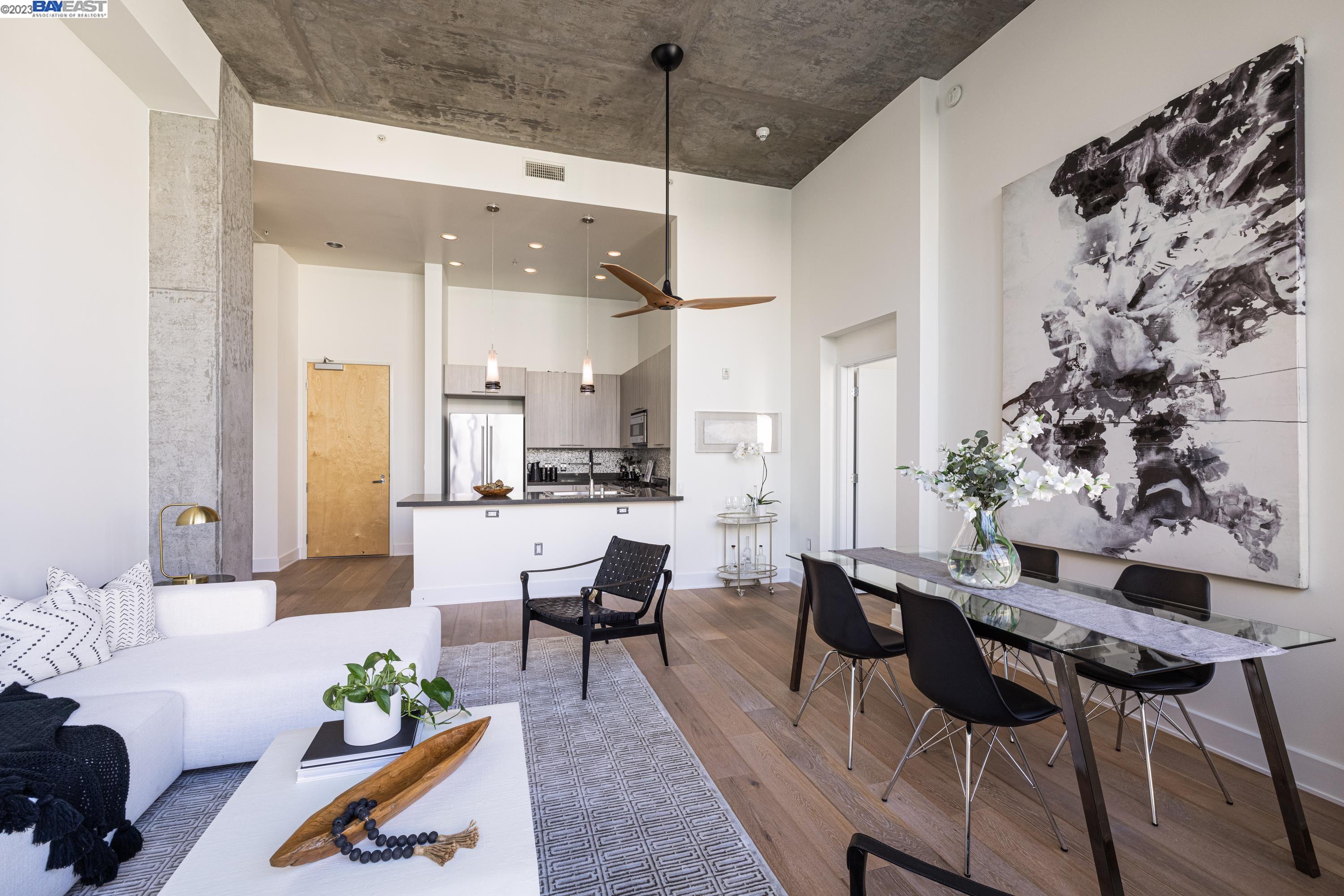 311 2nd Street, Unit 804 Oakland, CA 94607 - Photo 3 of 17 a living room with furniture and wooden floor