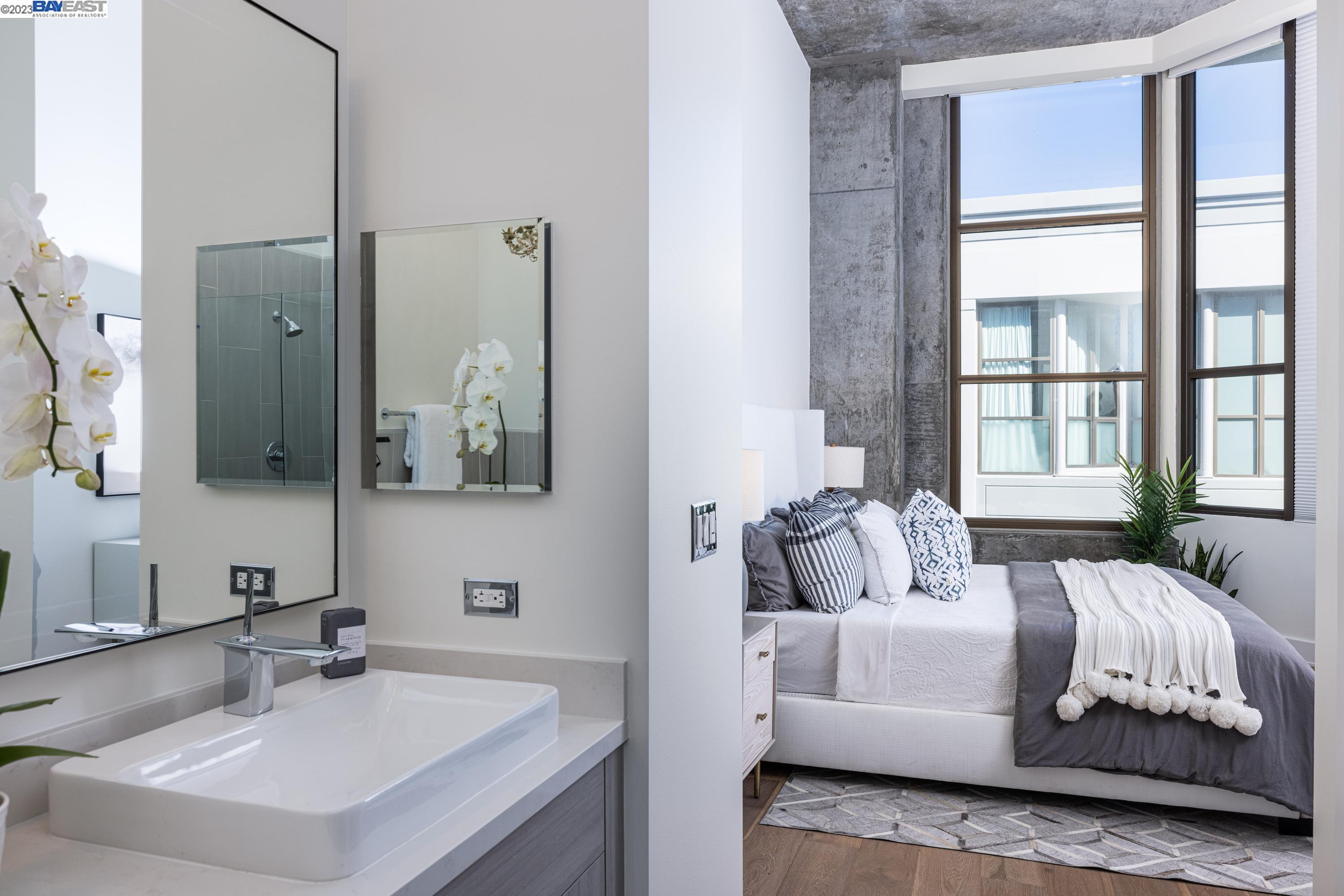311 2nd Street, Unit 804 Oakland, CA 94607 - Photo 10 of 17 a living room with furniture and a large mirror