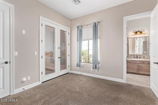 an empty room with windows and cabinet