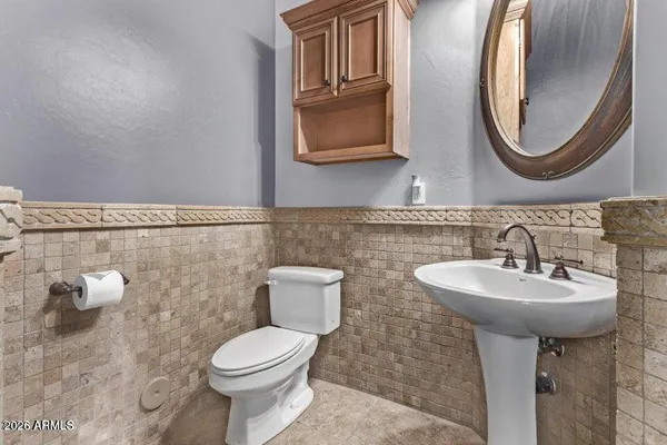 a bathroom with a toilet sink and mirror