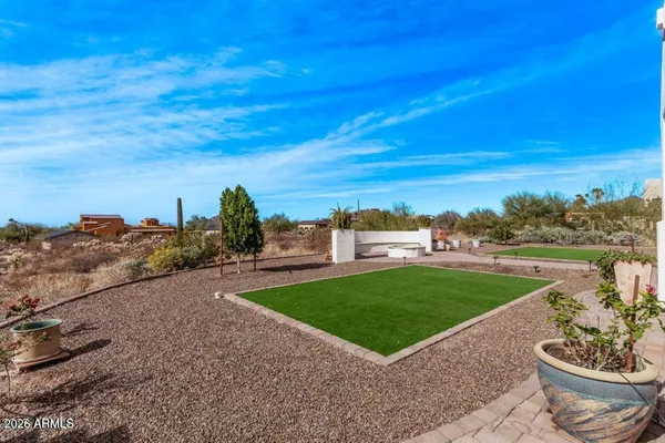 a view of a garden with a building in the background