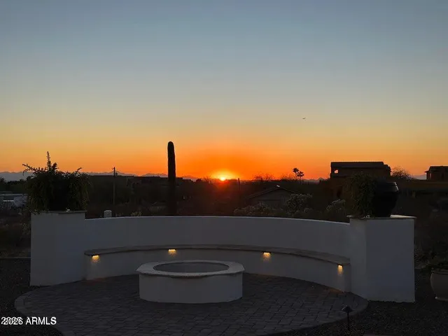a aerial view of a house with a garden and lake view