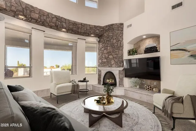 a living room with furniture a fireplace and a flat screen tv