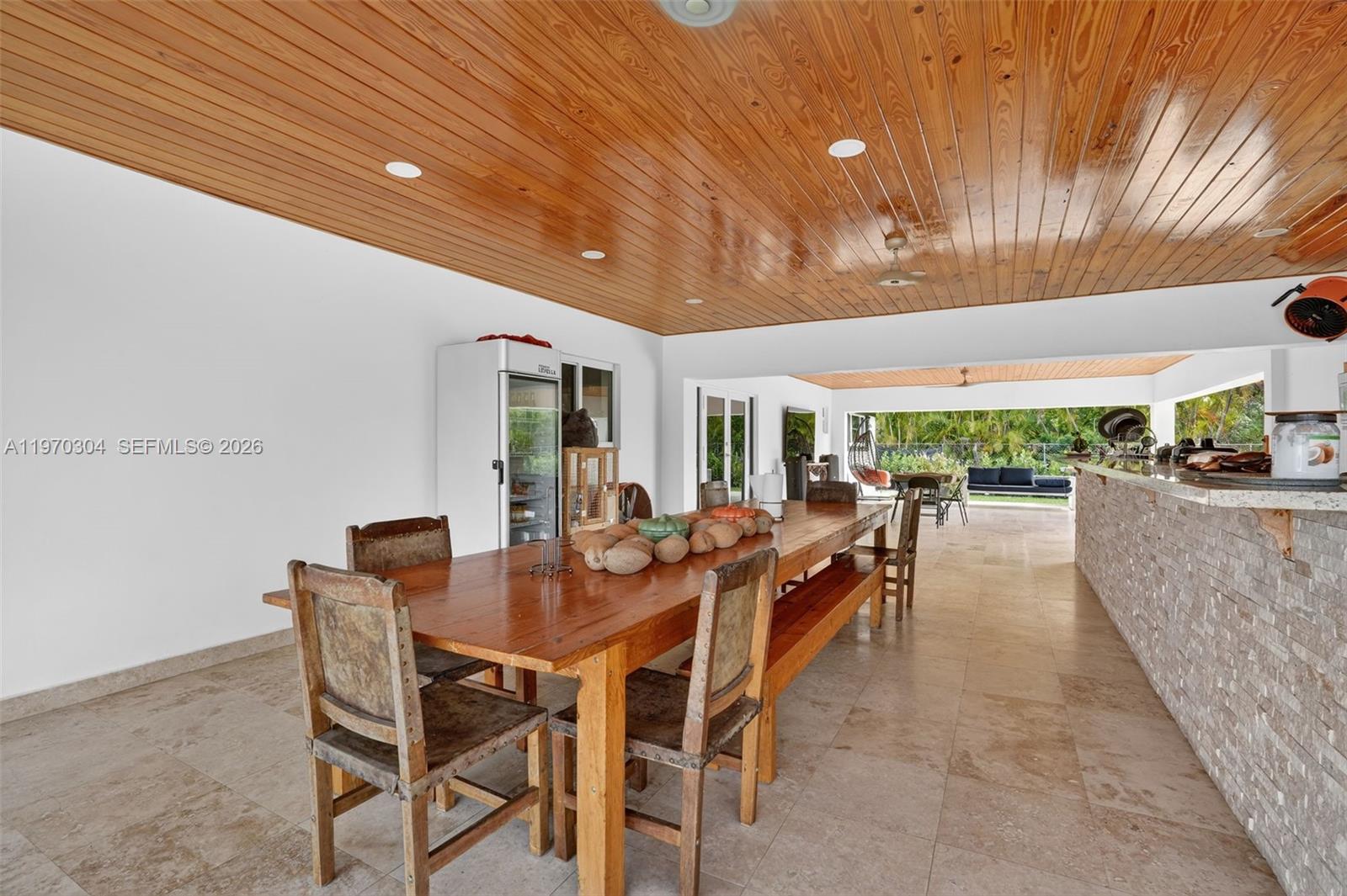 19390 Southwest 312th Street Homestead, FL 33030 - Photo 29 of 44 a dining room with furniture and a garden
