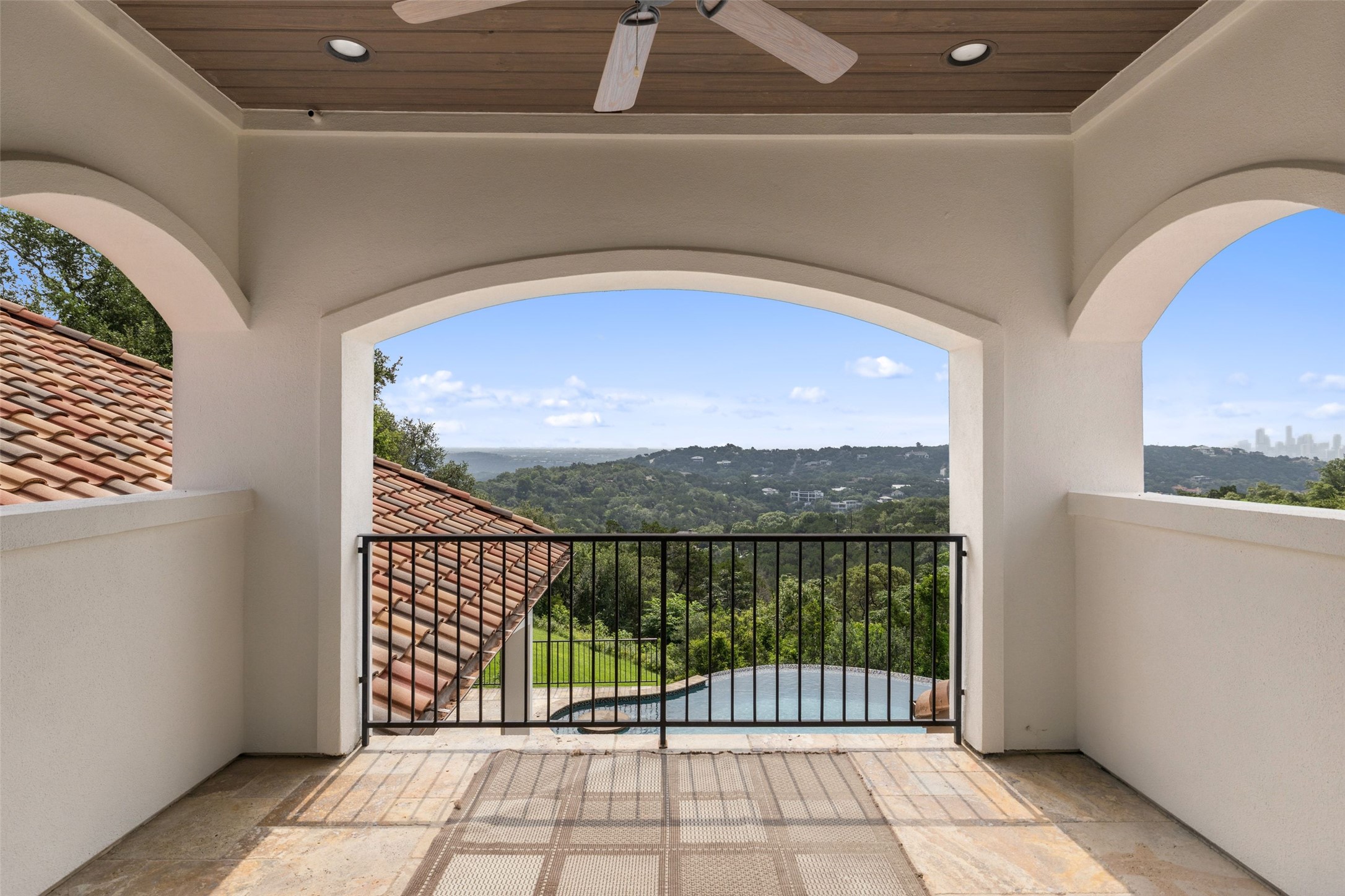 1414 The High Road Austin, TX 78746 - Photo 23 of 40 A spacious covered patio provides commanding views of the rolling hills and distant cityscape.