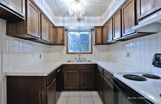 a kitchen with stainless steel appliances a sink stove and cabinets