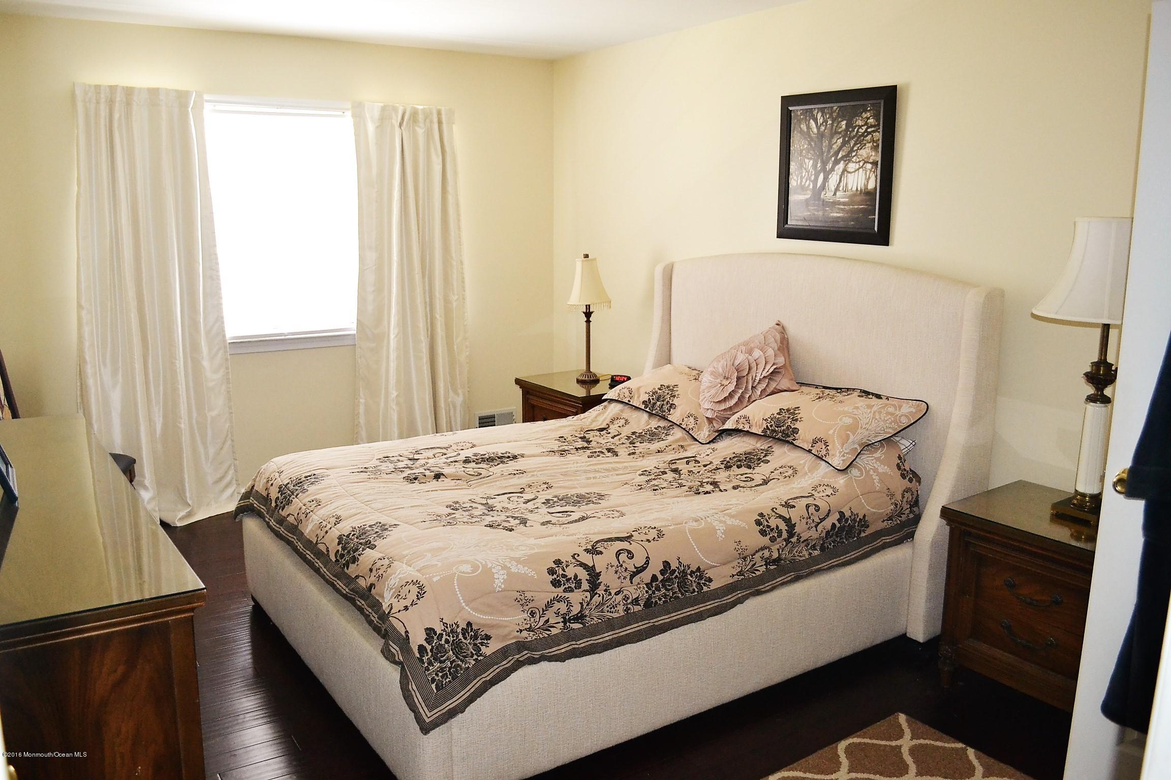 1104 Old Drift Road Point Pleasant, NJ 08742 - Photo 13 of 24 a bed sitting in a bedroom next to a window