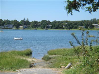 Undisclosed Address Orleans, MA 02653 - Photo 2 of 9 a view of a lake with houses in the back