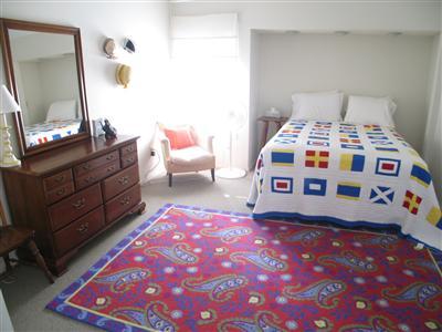 Undisclosed Address Orleans, MA 02653 - Photo 6 of 9 a bedroom with a bed and a dresser in it