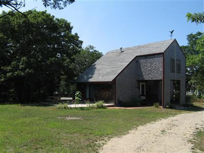 Undisclosed Address Orleans, MA 02653 - Photo 9 of 9 a front view of a house with garden