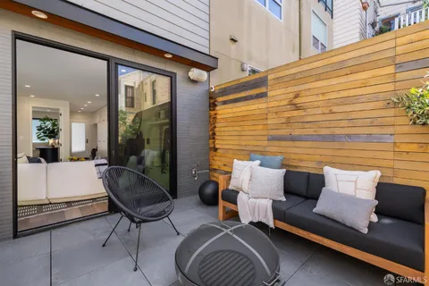 a living room with furniture and a dining table