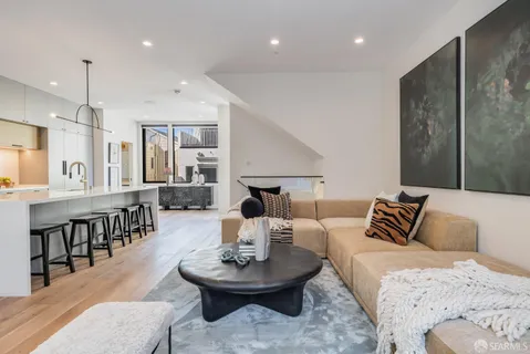 a kitchen with a table chairs sink and cabinets