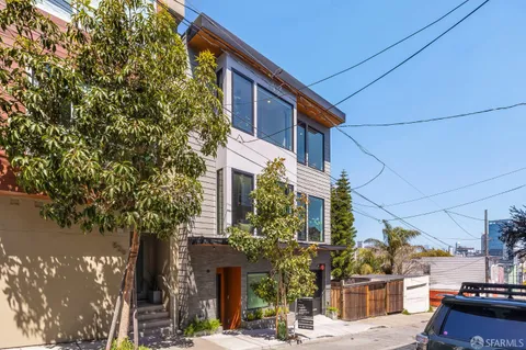 a front view of a house with trees