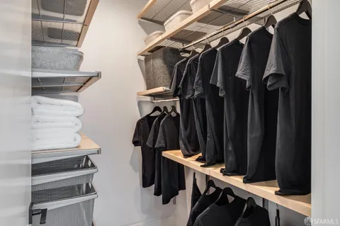 a bed room with a bed a mirror and a potted plant