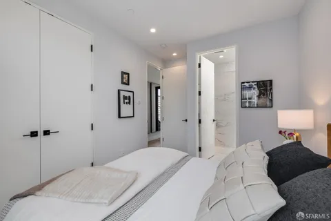 a bedroom with a bed and glass wall