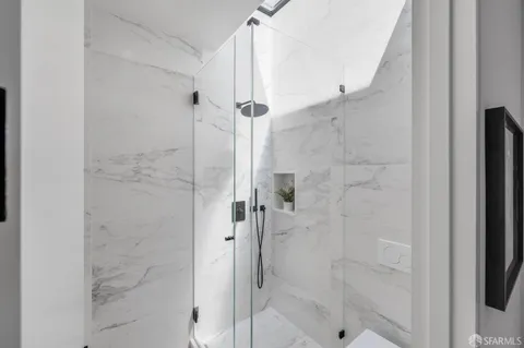 a bathroom with a tub sink and mirror