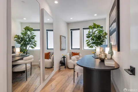a living room with lots of furniture and a view of kitchen