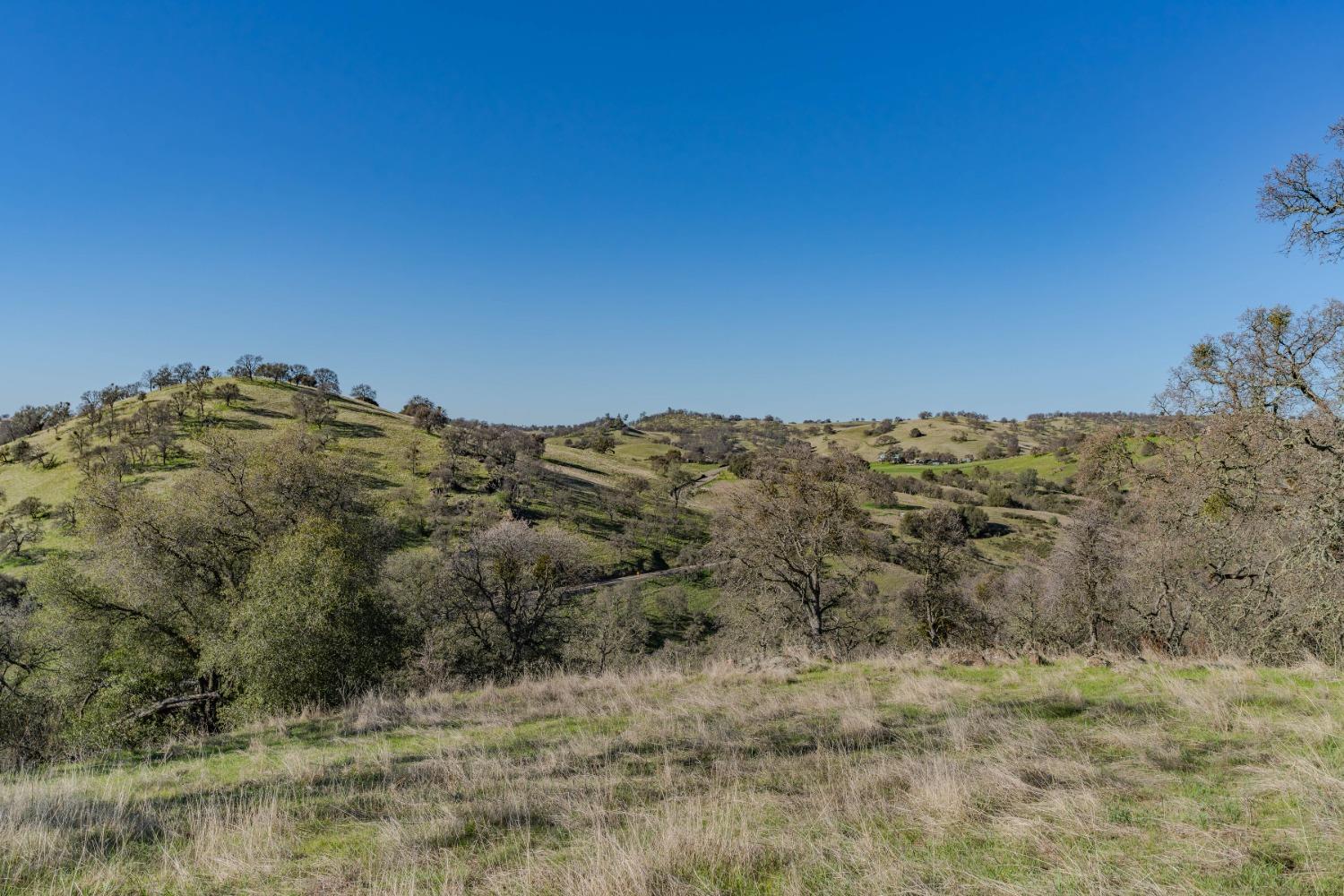 7220 Stony Creek Road Jackson, CA 95642 - Photo 12 of 60 a view of a large building with mountains in the background