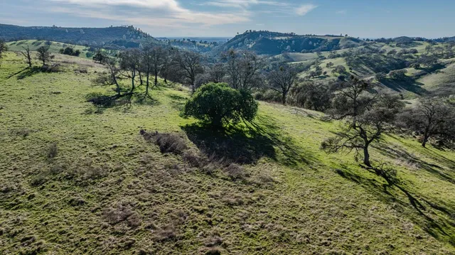 an aerial view of mountains in back