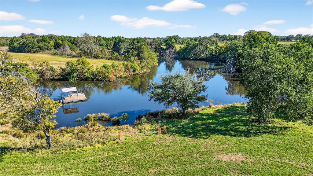 912 East Bewley Road Whitesboro, TX 76273 - Photo 2 of 30 a view of a lake with a house in the background