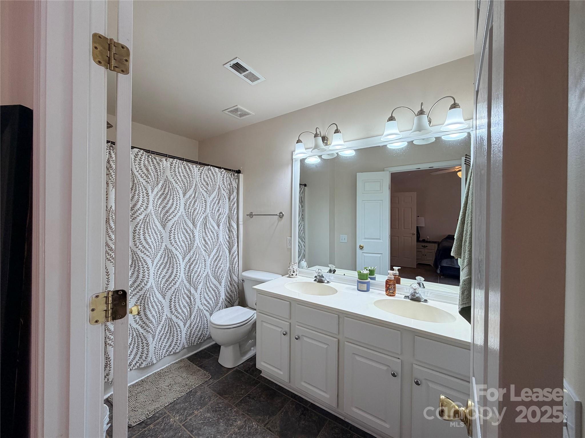 6836 Rothchild Drive Charlotte, NC 28270 - Photo 20 of 25 a bathroom with a double vanity sink mirror and toilet