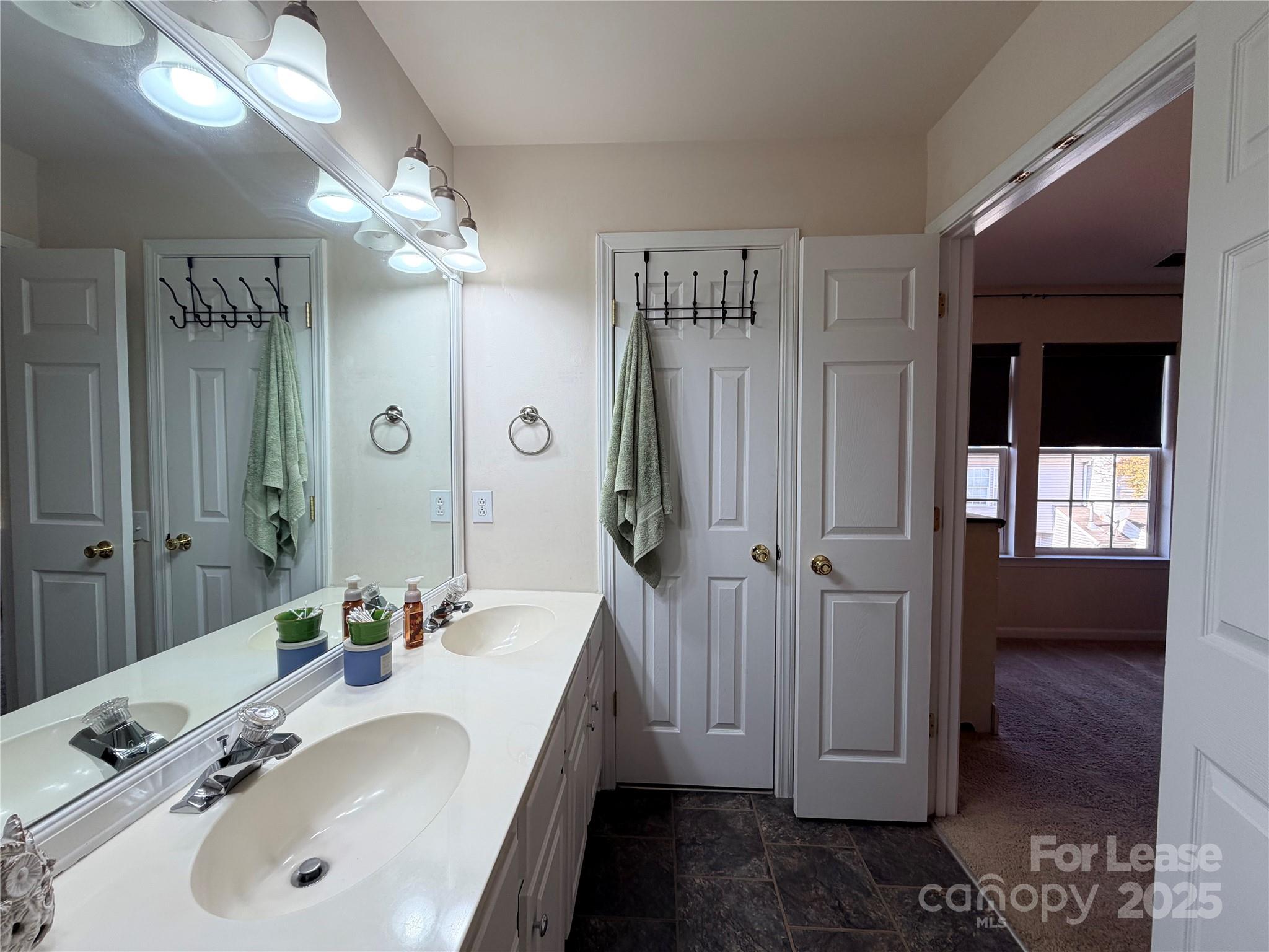 6836 Rothchild Drive Charlotte, NC 28270 - Photo 22 of 25 a bathroom with a sink a mirror and a shower