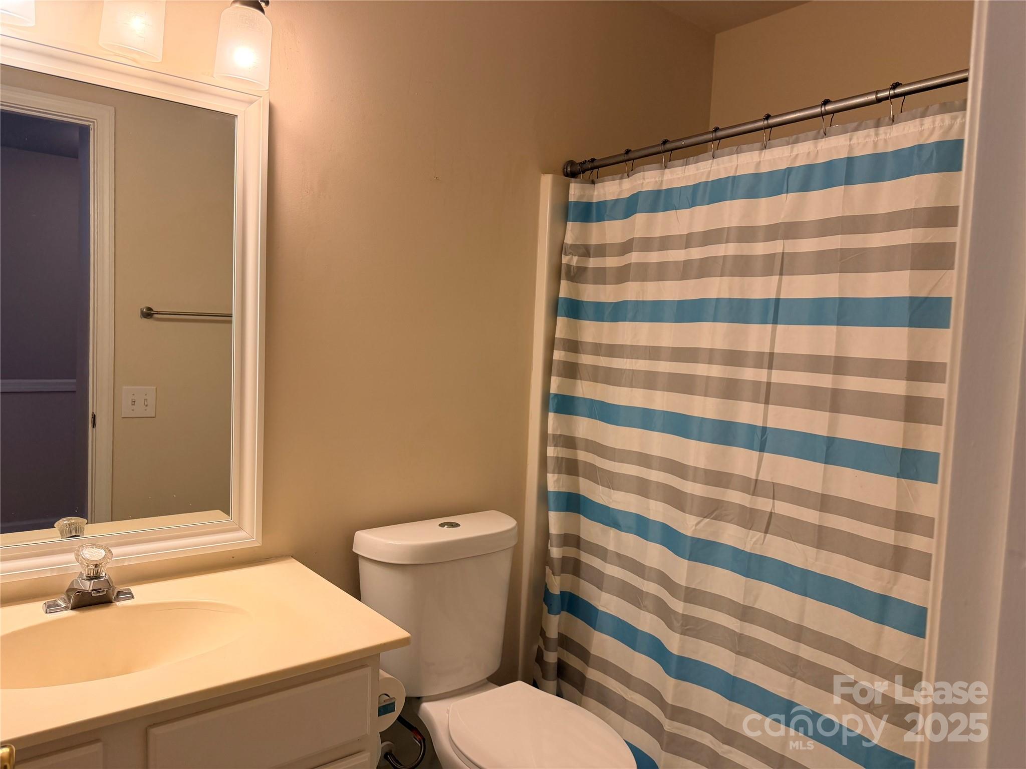 6836 Rothchild Drive Charlotte, NC 28270 - Photo 24 of 25 a bathroom with a sink and a mirror