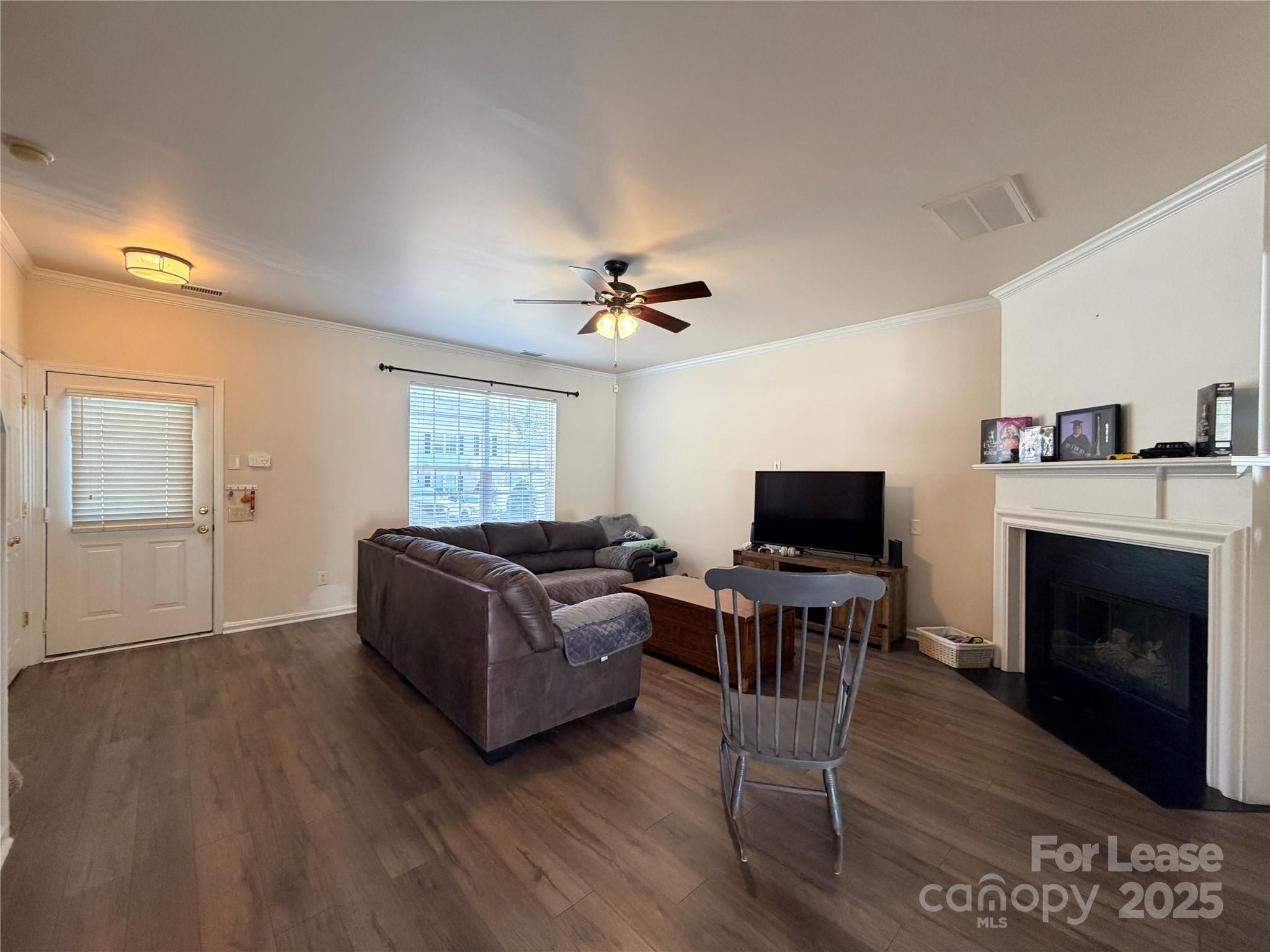 6836 Rothchild Drive Charlotte, NC 28270 - Photo 8 of 25 a living room with furniture a fireplace and a flat screen tv