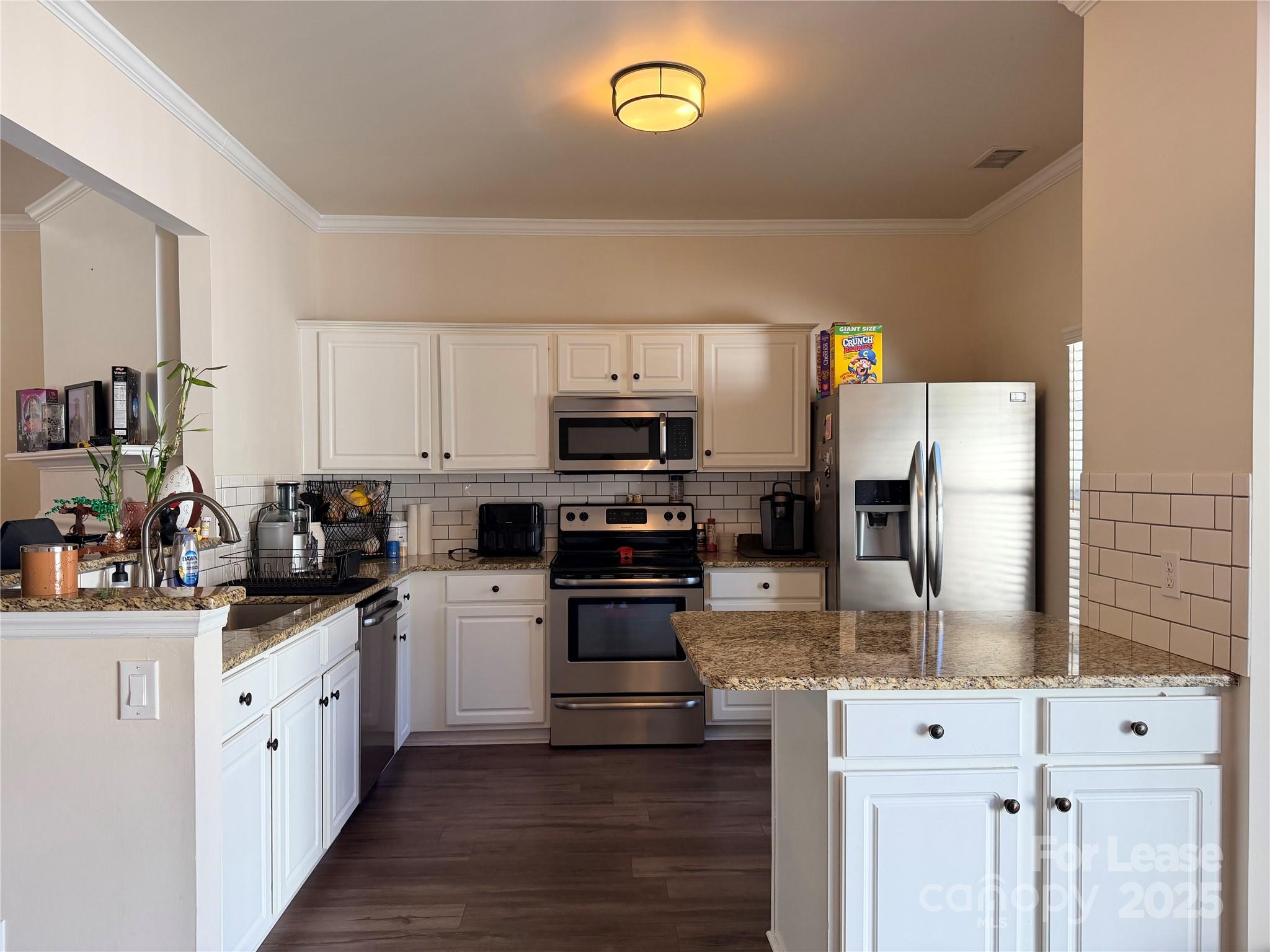 6836 Rothchild Drive Charlotte, NC 28270 - Photo 9 of 25 a kitchen with stainless steel appliances a stove microwave and refrigerator