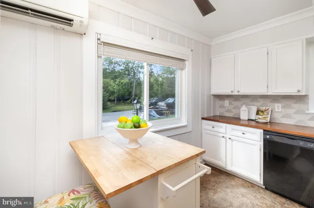 a kitchen with granite countertop a sink stove and refrigerator