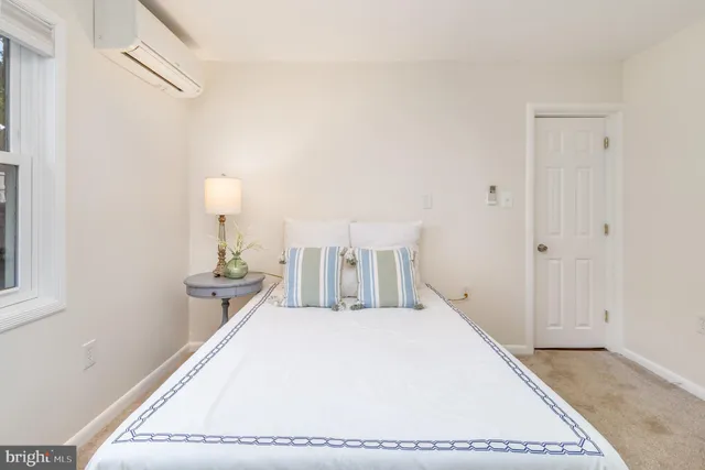 a bedroom with a bed and wall painting