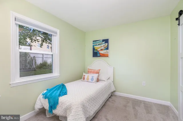 a bedroom with furniture and a large window