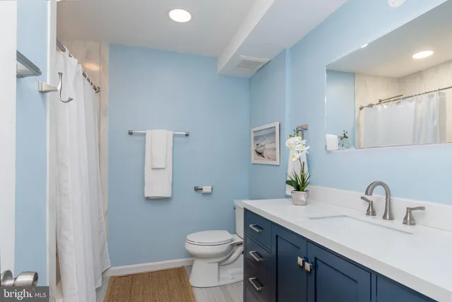 a bedroom with a bed and a night stand