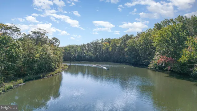 an aerial view of residential house with outdoor space and trees all around